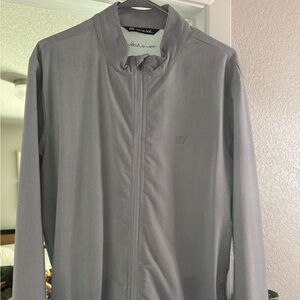 Striped blue and white Travis Mathew jacket.